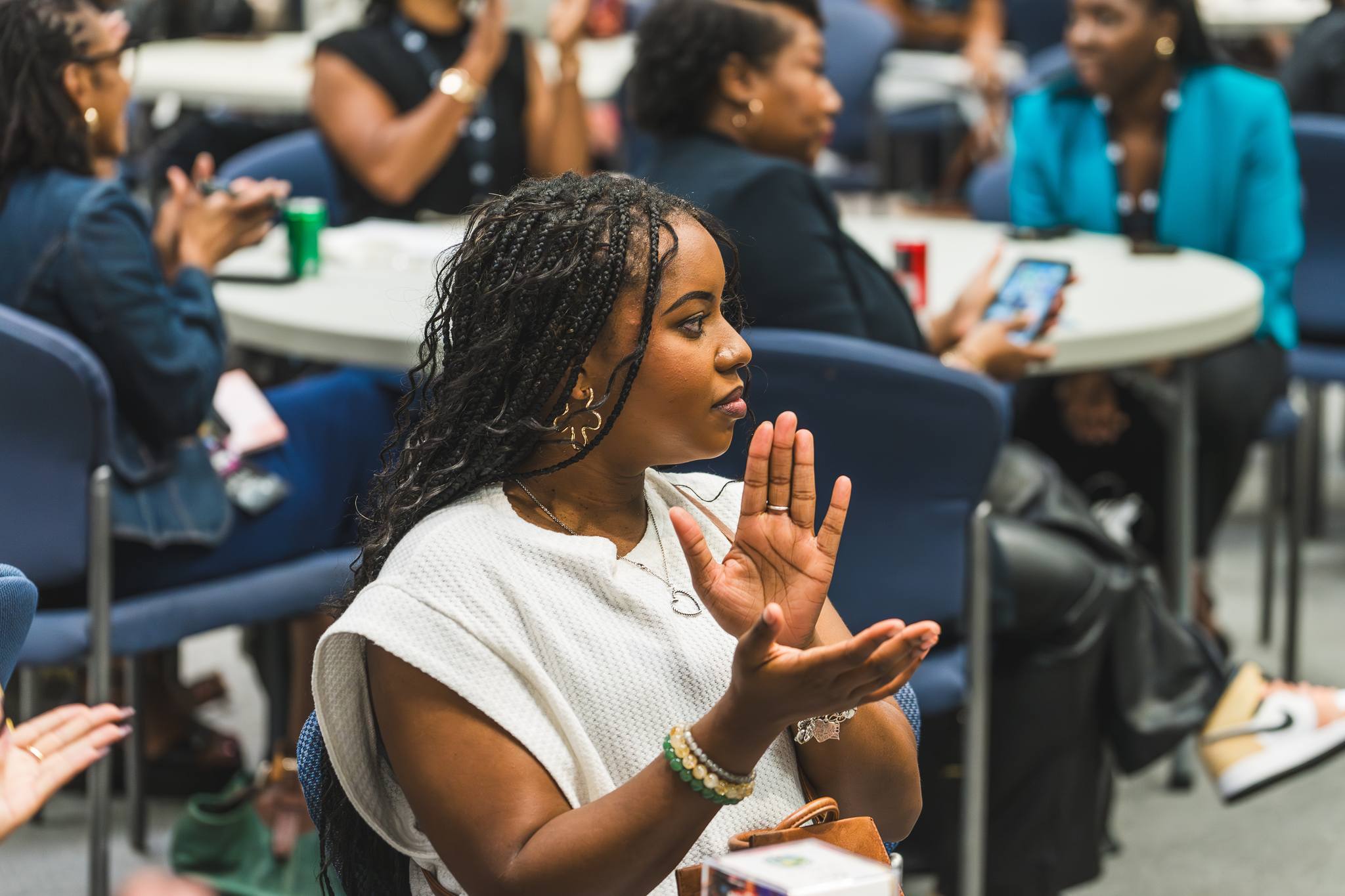 Woman clapping enthusiastically in an engaged audience